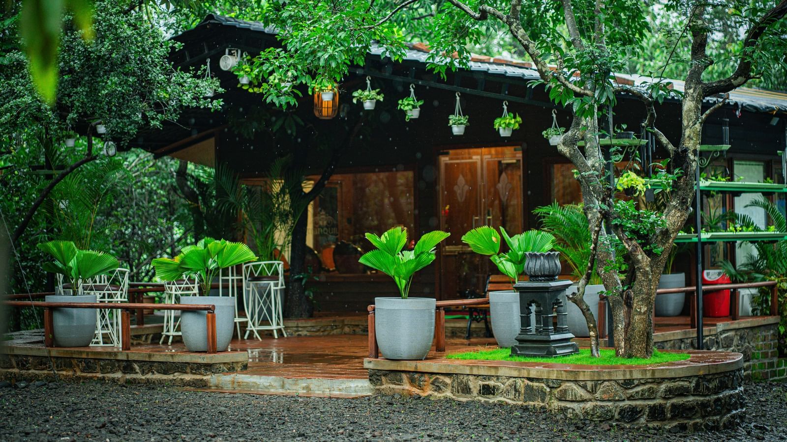 A wooden building with a tiled roof, surrounded by numerous potted plants - Tranquil Piedmont Estates & Resort