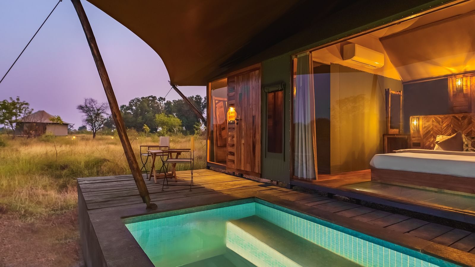 A view from outside of a tent with a plunge pool at Trees N Tigers, Tadoba.