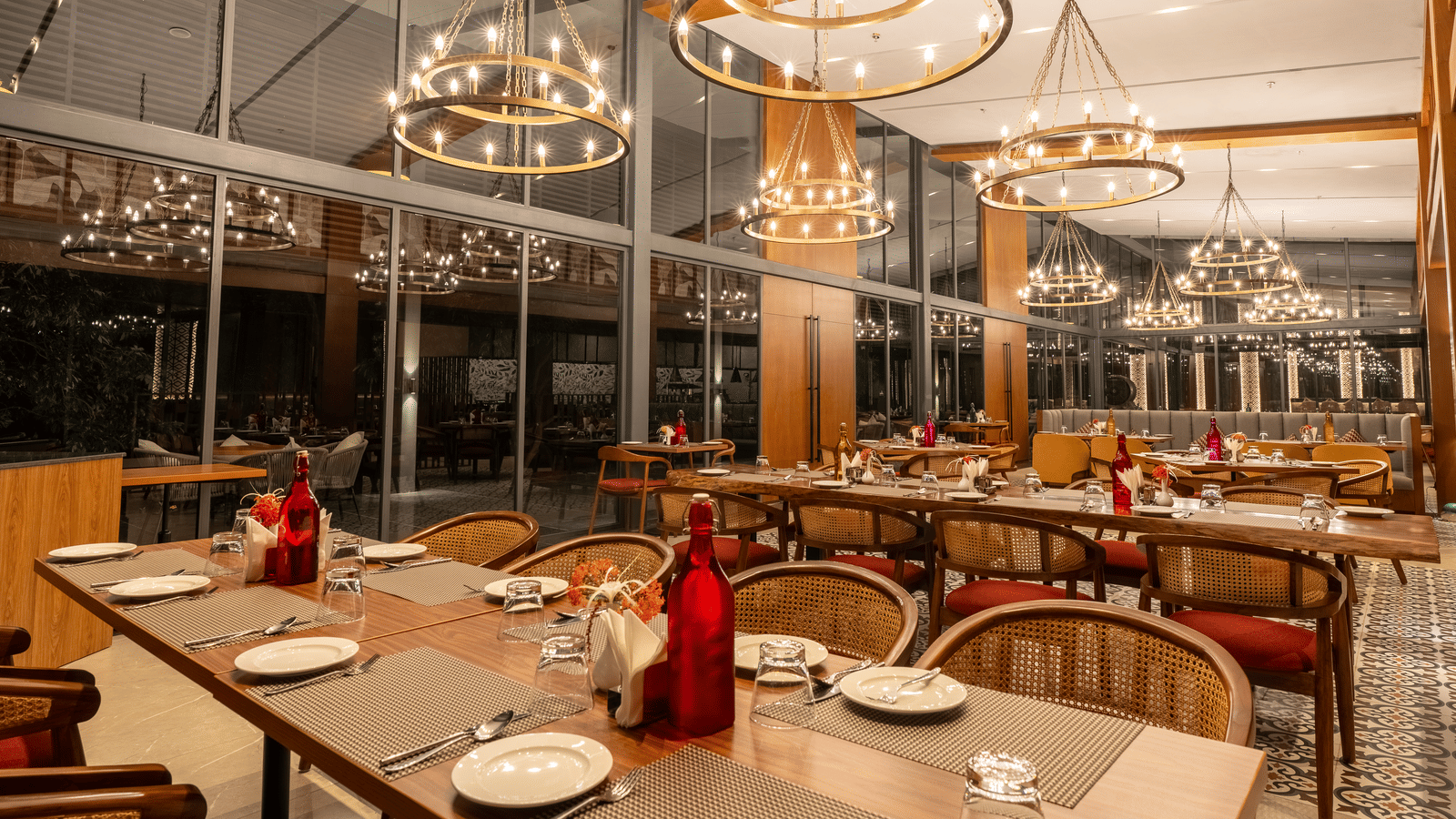 An inviting dining area at Wyndham Garden featuring neatly arranged tables and contemporary chandeliers.