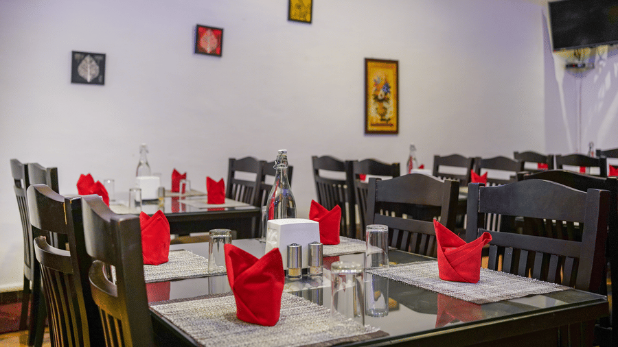 Image of a dining space with napkins placed on the table at Coorg Jungle Camp Backwater Resort, Kushalnagar.