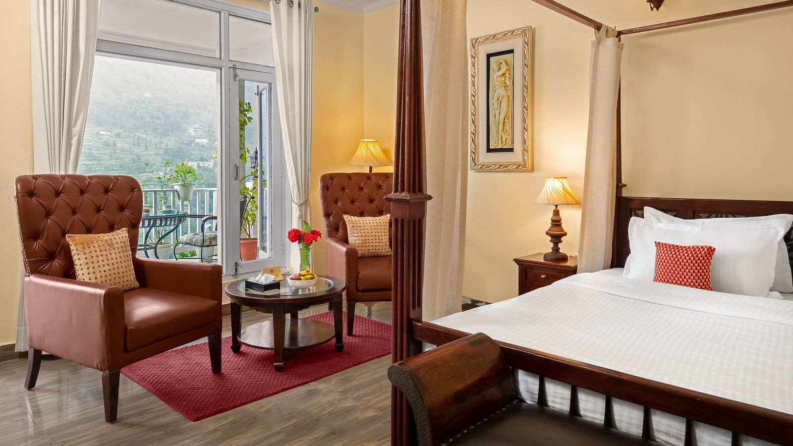 An image of bedroom with king size bed, a bedside table lamp, two chairs and a centre table - Suvaasa, Ramgarh