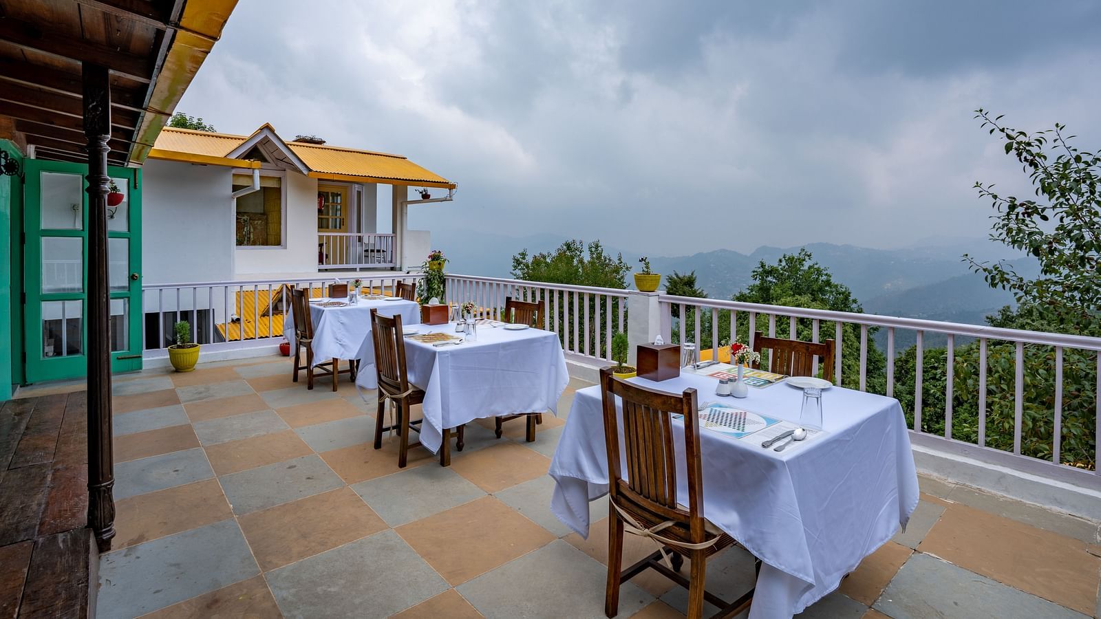 A scenic balcony view of the cloud covered hills.