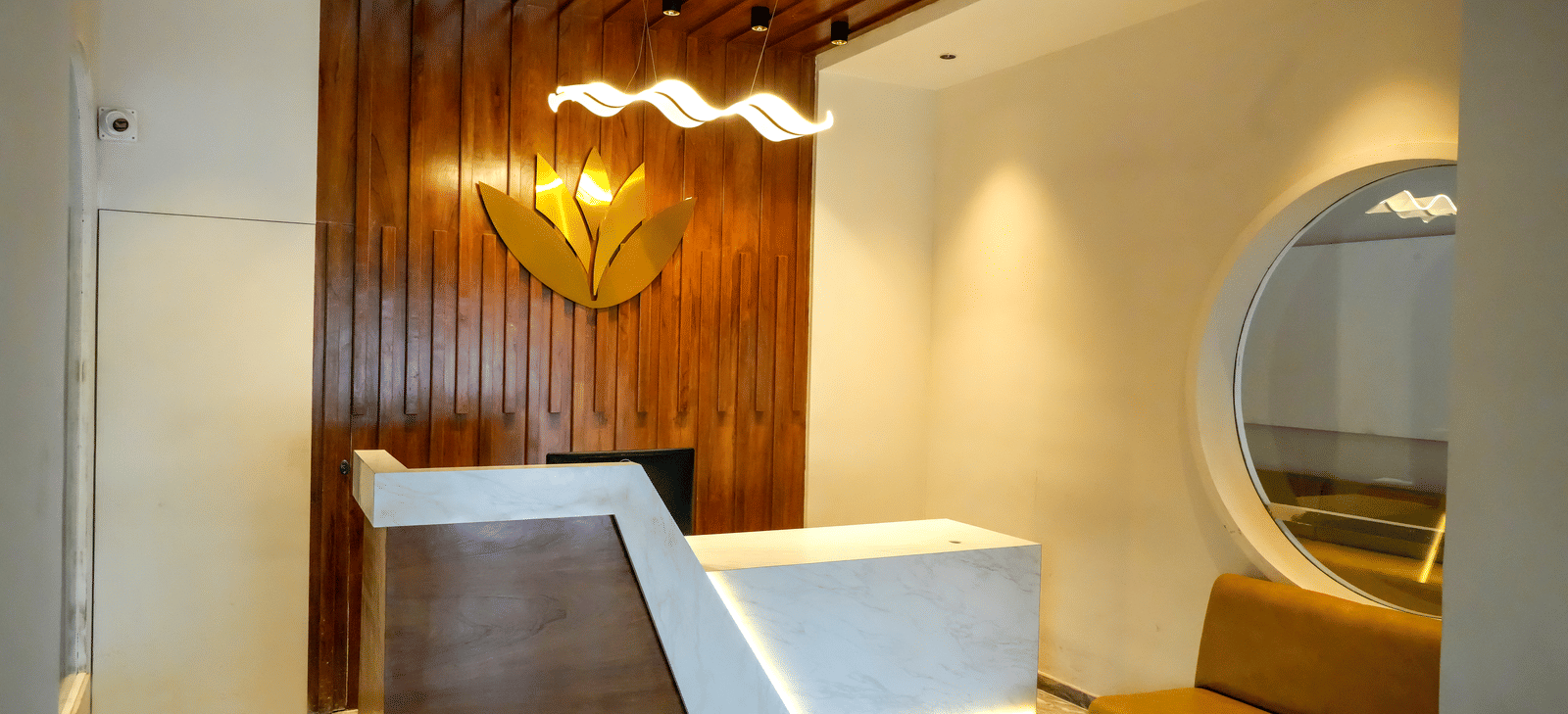 Hotel reception area with counter and seating at Pravasa Hotel, Kolhapur.