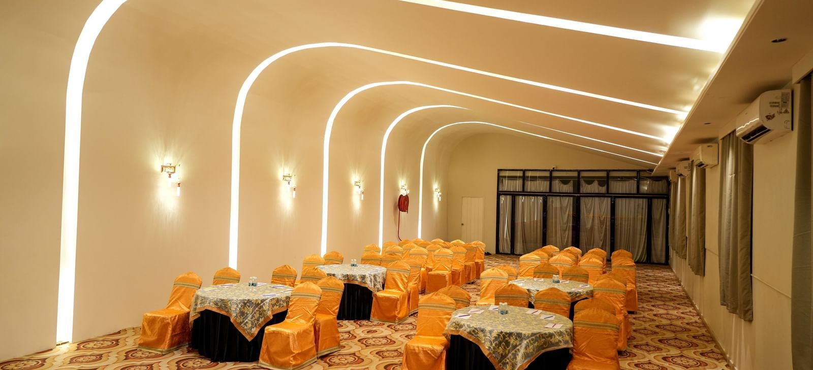 Elegant dining area with warm lighting and stylish seating at Pravasa Hotel Kolhapur.