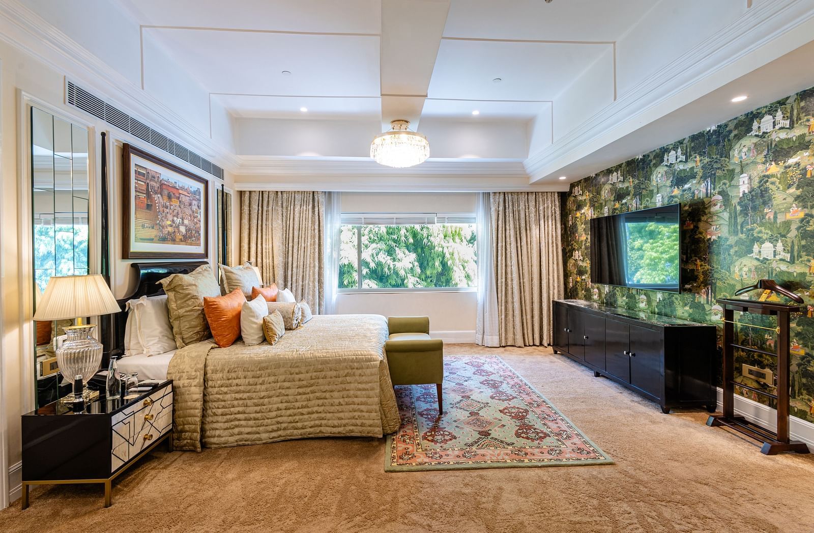 Presidential Suite at The Claridges New Delhi, featuring a king-sized bed with a bedside lamp and a wall-mounted TV