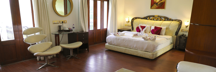 a king bed with sofas inside King Suite - White pearl suites by rosetum 