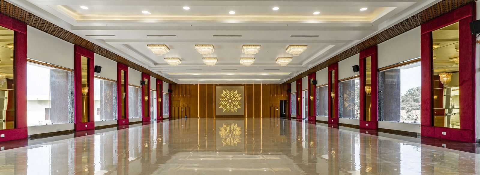 A long, empty hallway with a highly polished floor that reflects the ceiling and walls - Bamboo Saa Mulberry Resort, Pushkar