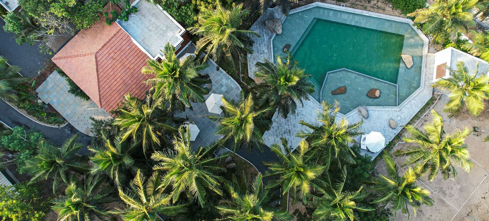 Aerial view of a private beach resort near Pondicherry with a swimming pool | Mango Hill Shallow Beach Resort ECR