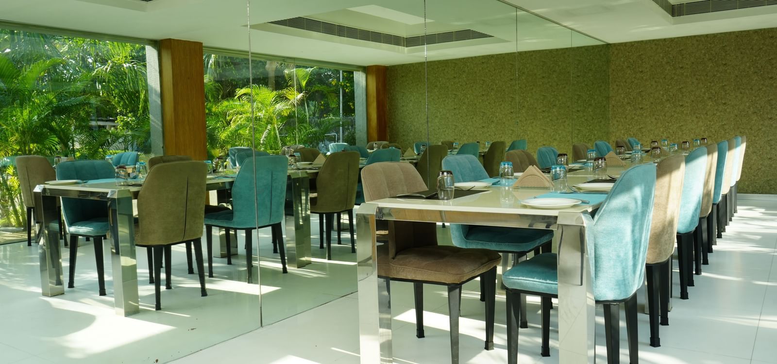 A spacious restaurant dining area with neatly arranged tables and chairs at Grande Bay Resort & Spa.