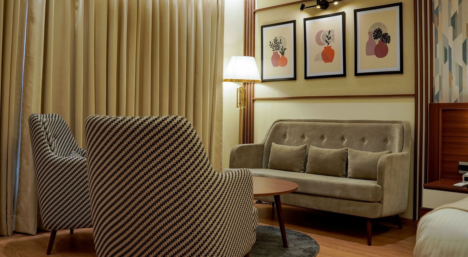 A close-up shot of the separate seating area with a tall lamp in the corner in the premium room at M2 Square by Monday Premium.