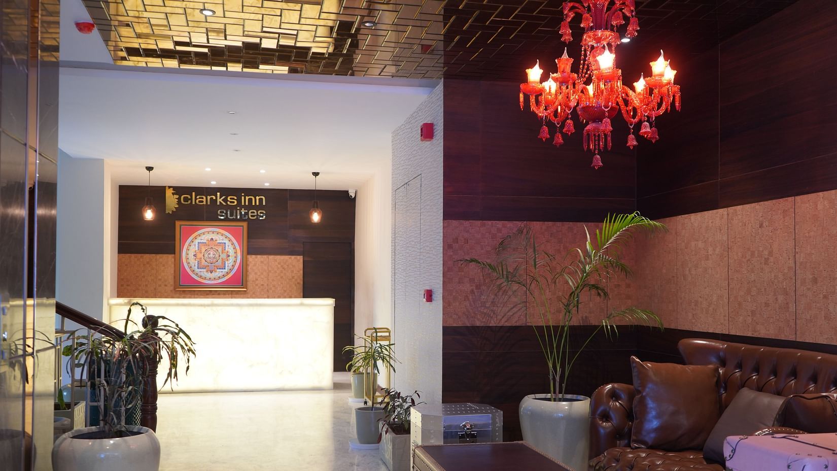 Lobby featuring a reception desk and sitting space above which a chandelier is hanging