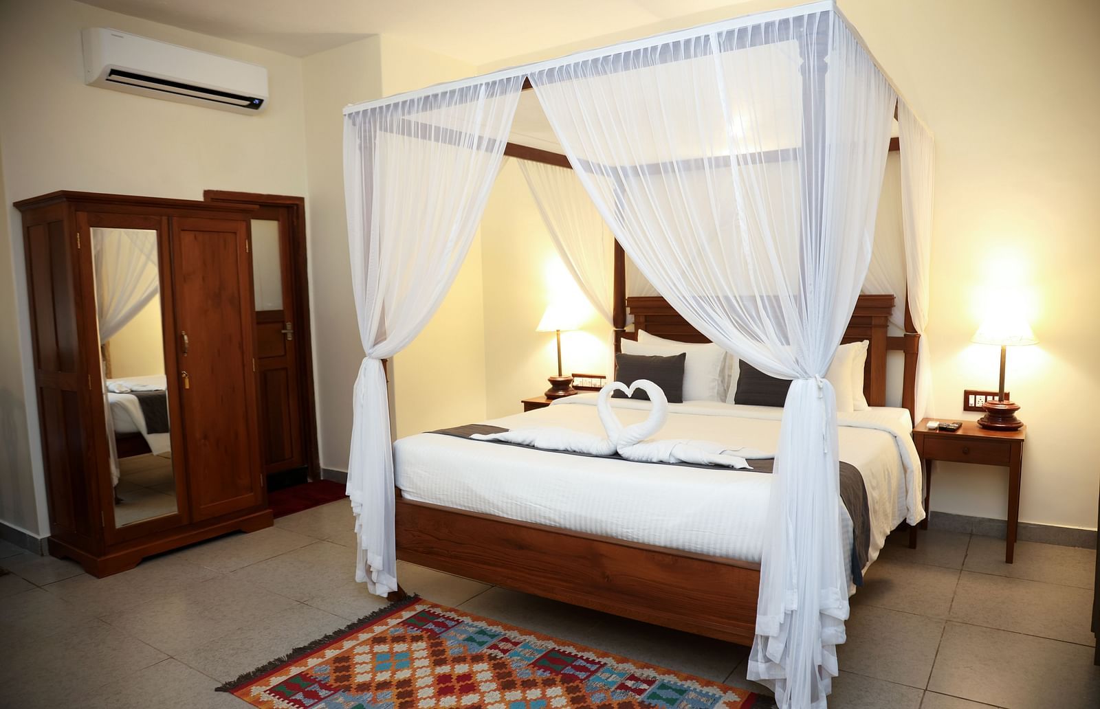 A four-posted bed decorated with pieces of cloth on each angles | Mango Hill La Serene, Pondicherry