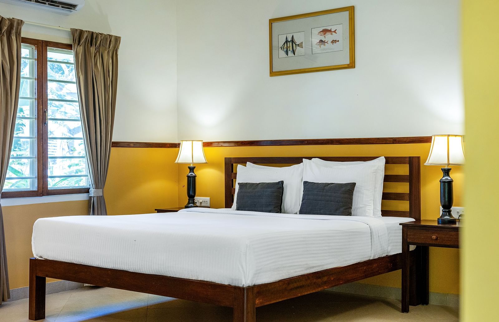 Double bed with nightstands and lamps in a plainly decorated room | Mango Hill Shallow Beach Resort ECR