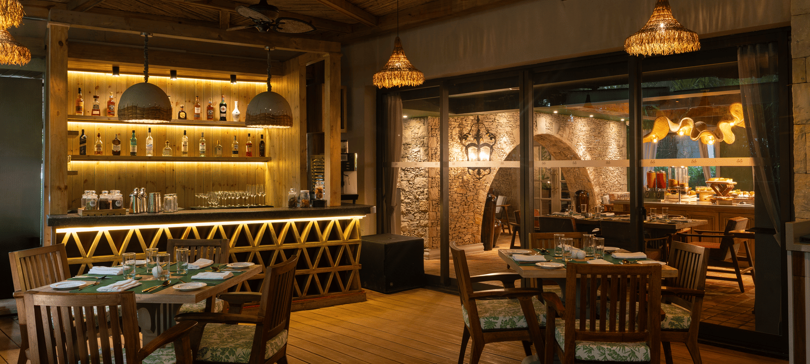 The indoor dining area of Mila Restaurant at The Evren, Vagator, with elegant lighting.
