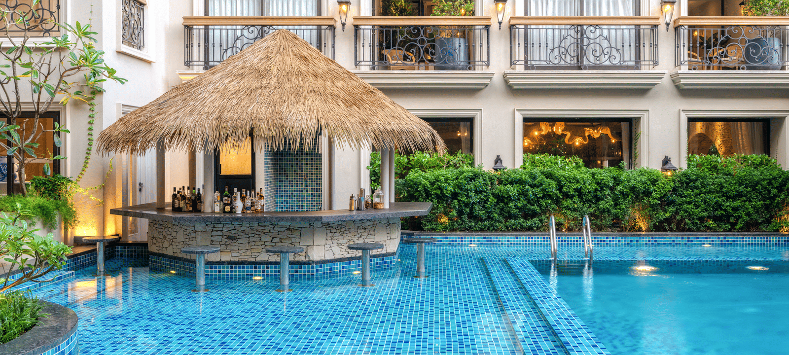 The Splash Pool Bar with calm waters in the swimming pool in the foreground at THe Evren, Vagator.