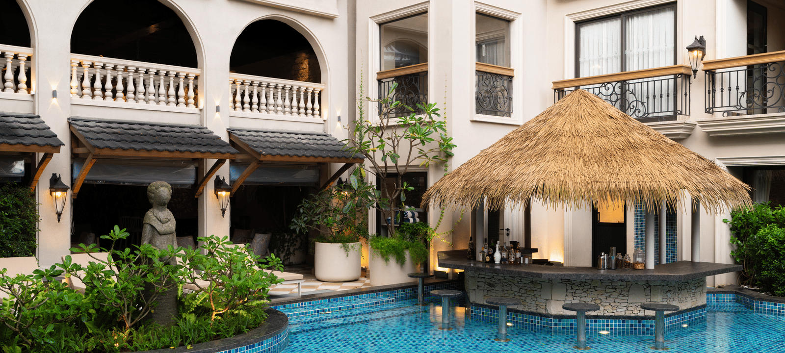 Side-view shot of the Splash Pool Bar with thatched roof above it at The Evren, Vagator.