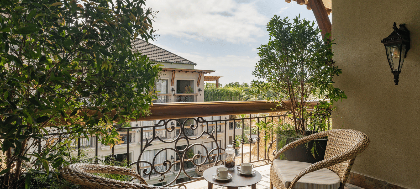 A beautiful balcony with an outdoor seating area overlooking the building opposite to it from the Premium Room at The Evren, Vagator.