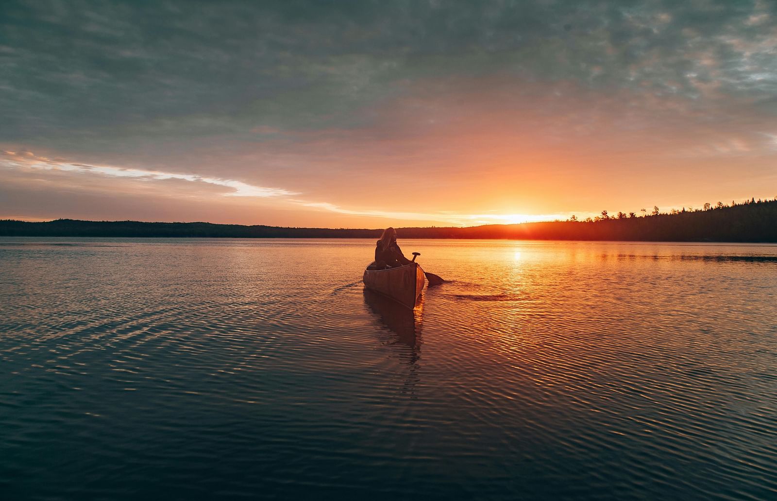Photo of a person riding a kayak.