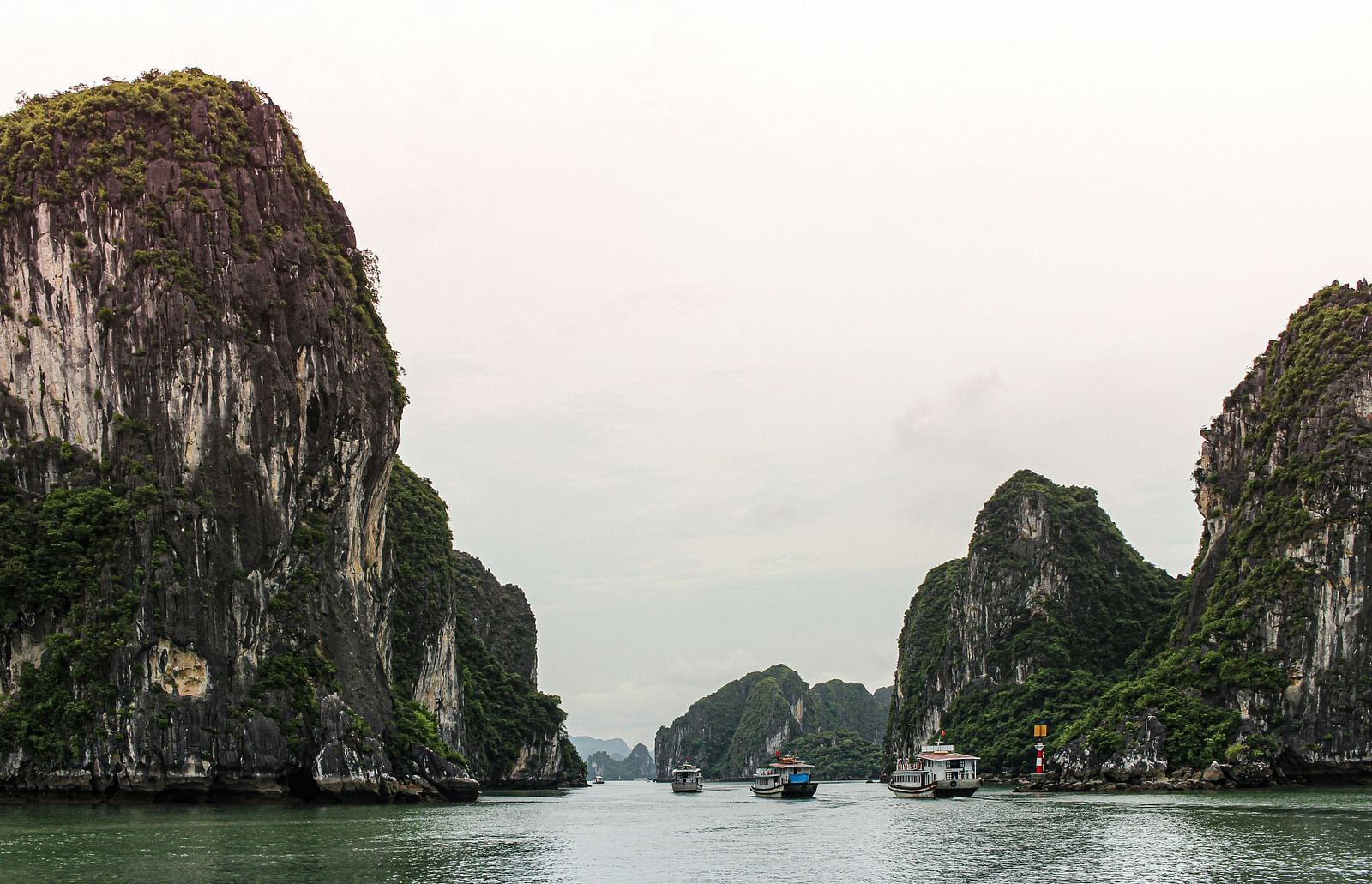 An overview of Ha Long Bay with rock islands, waterbody and boats in view