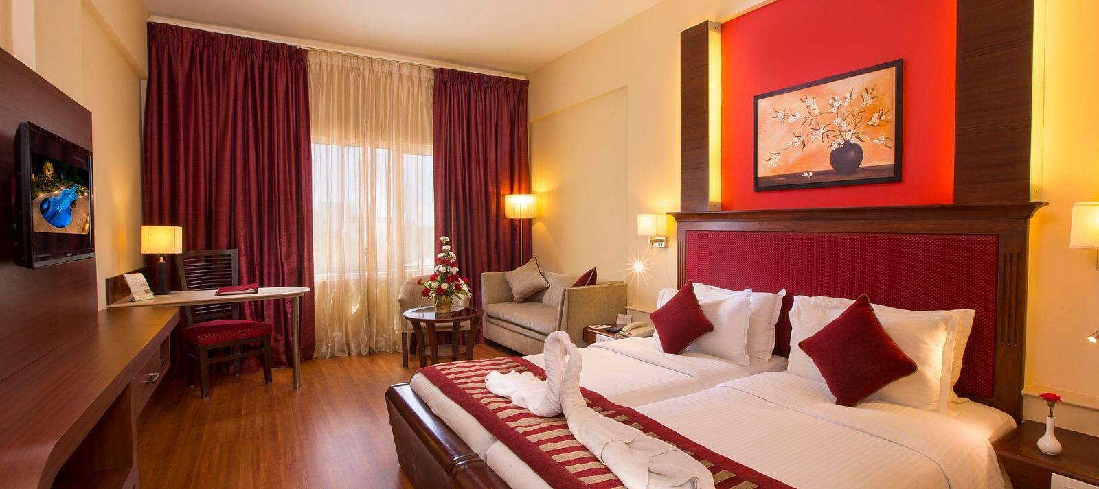 Superior Room featuring twin beds, sofa and a television at Hotel Atithi - TGI Grand, Pondicherry