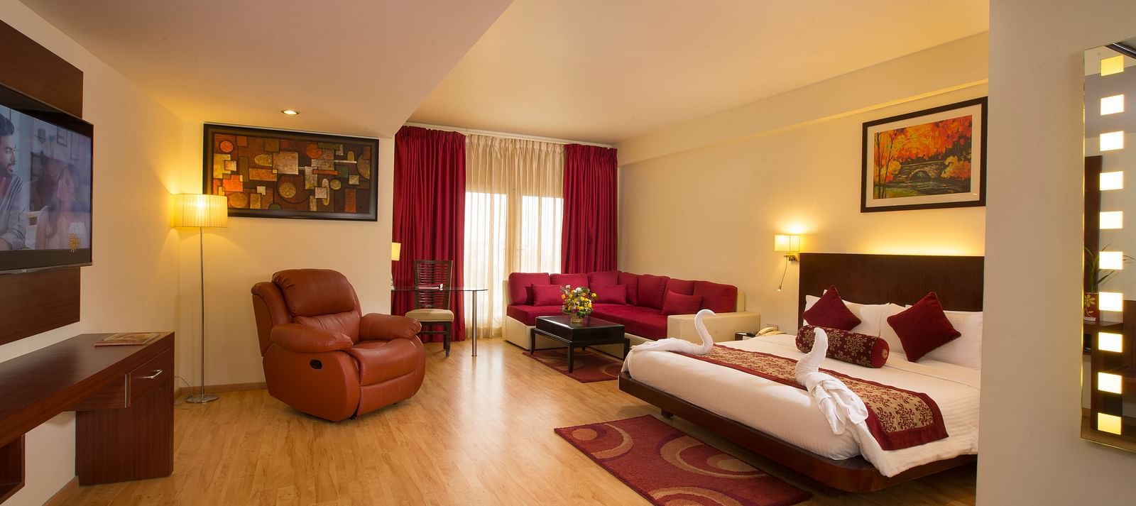 a view of Family Suite featuring a bed, a television and a recliner at Hotel Atithi - TGI Grand, Pondicherry