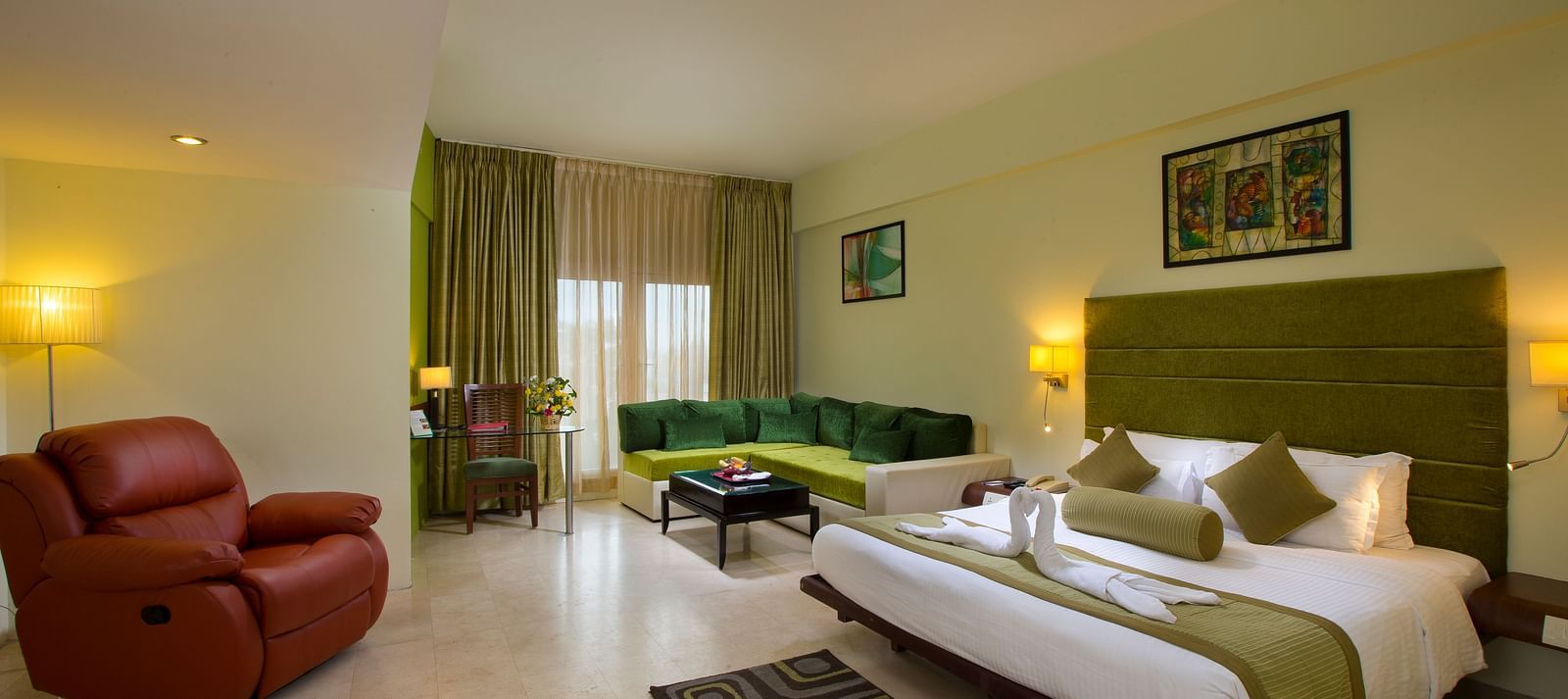 Family suite featuring a bed, a sofa and recliner at Hotel Atithi - TGI Grand, Pondicherry