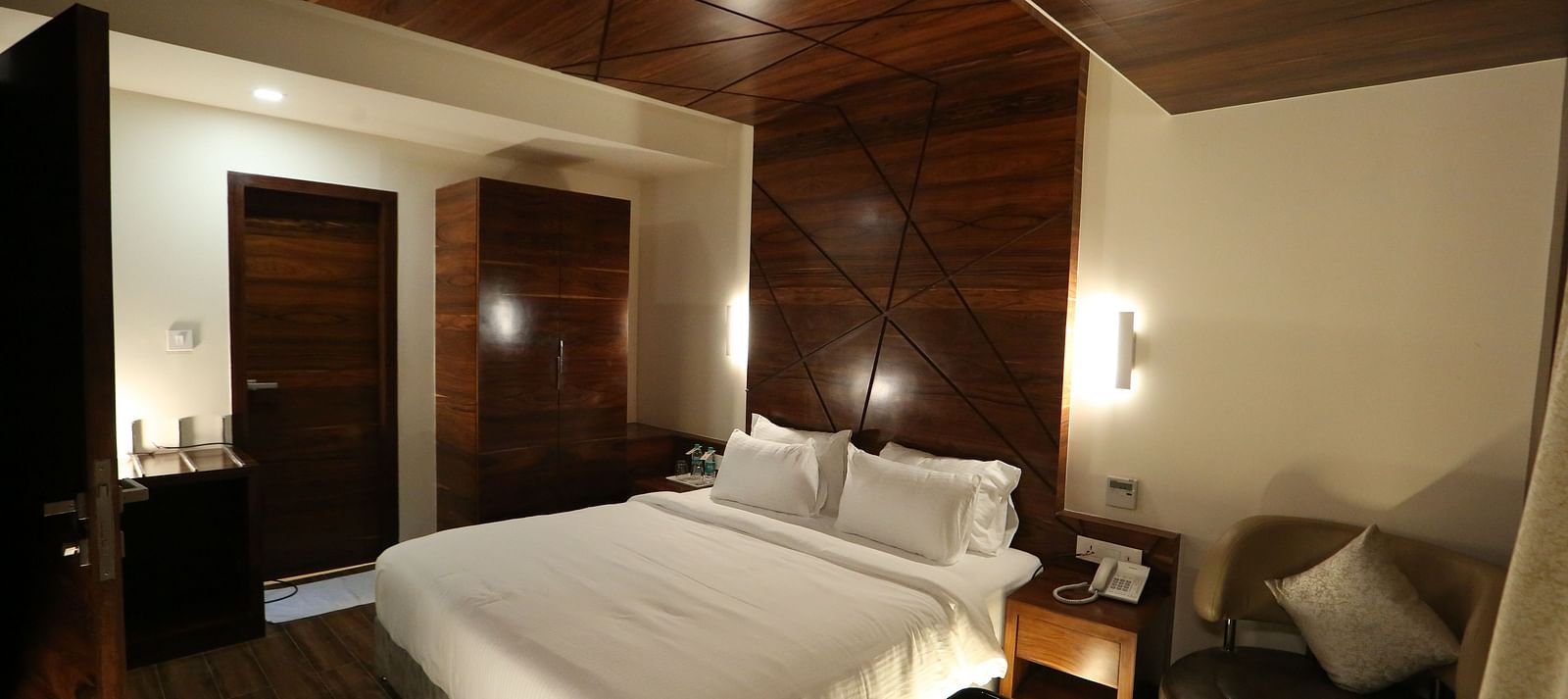 Premium Suite featuring a king size bed and bedside tables. - TGI SPS Grand, Coimbatore