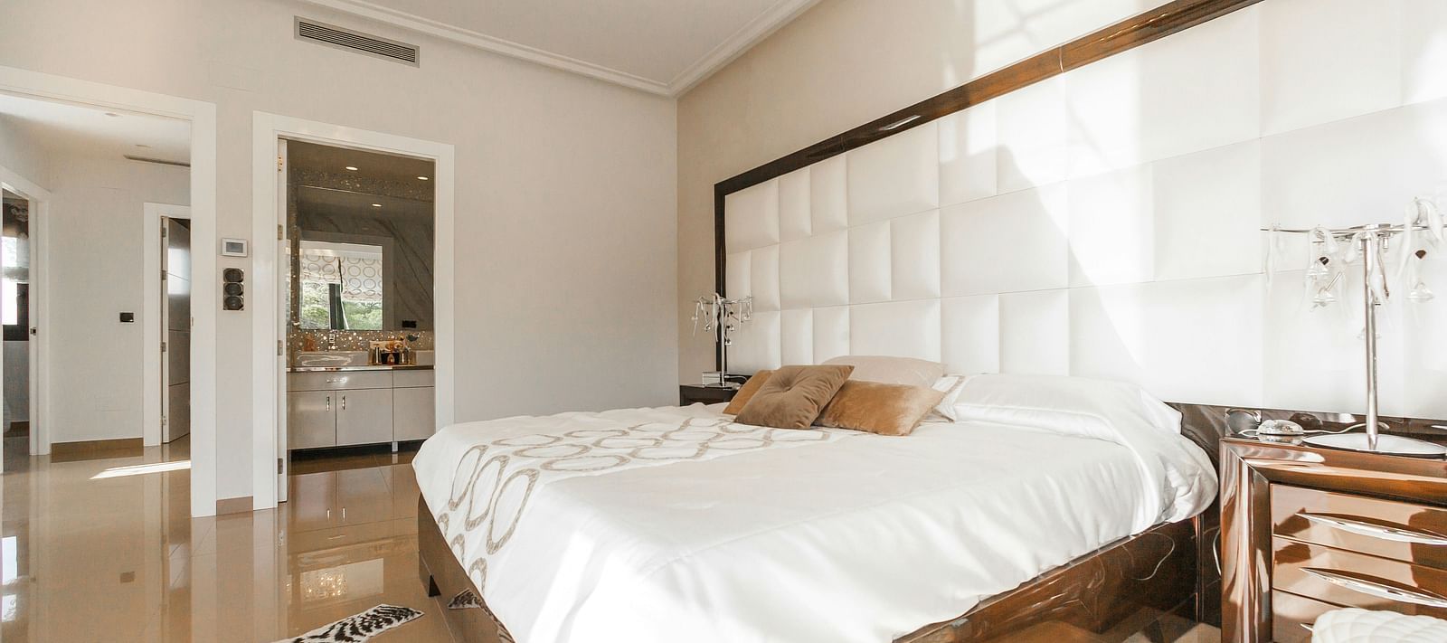 Image of a room with bed, bedside table and a rug by the feet of the bed | Faraway Cottages, Auli