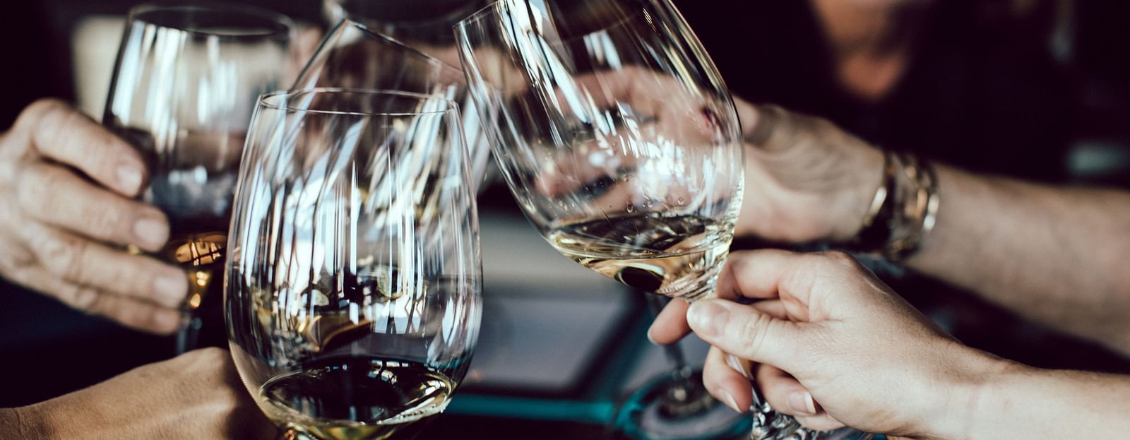 a group of people clinking their wine glasses