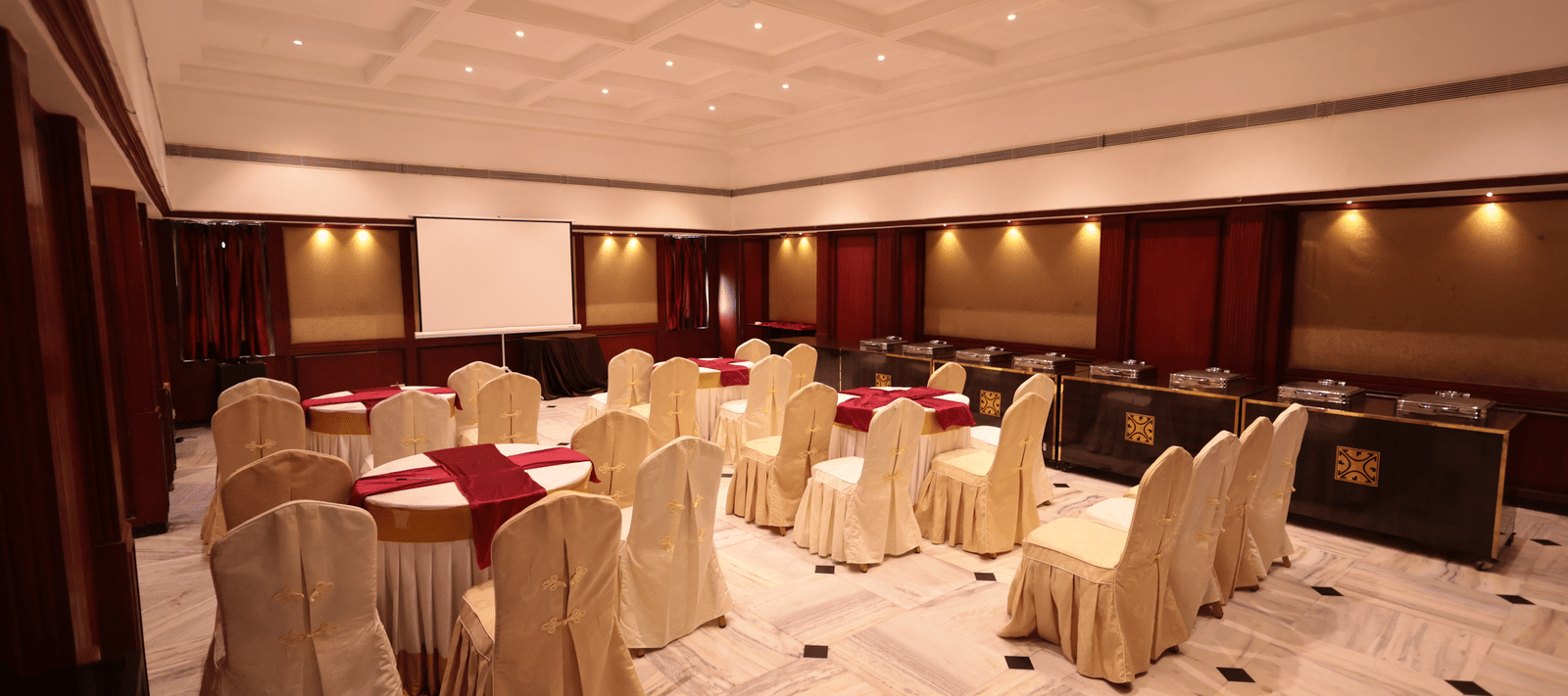 A banquet hall view from behind, with decorated tables and chairs at Cenneys Gateway.