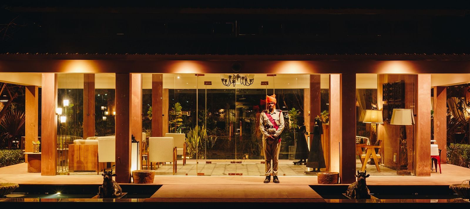 Night view of the recepetion area with a guard standing in front at Surpura Bagh.