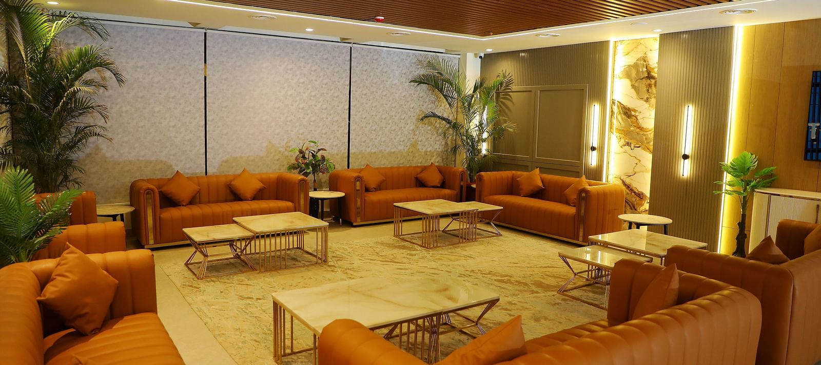 Elegant guest lounge at Town Square Suites with plush sofas and warm lighting