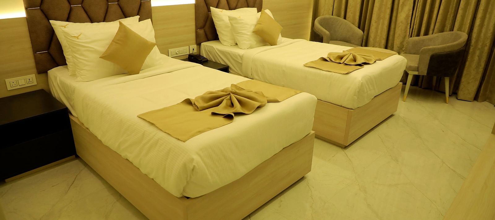 Twin bed deluxe room at Town Square Suites with elegant furnishings and cozy linens