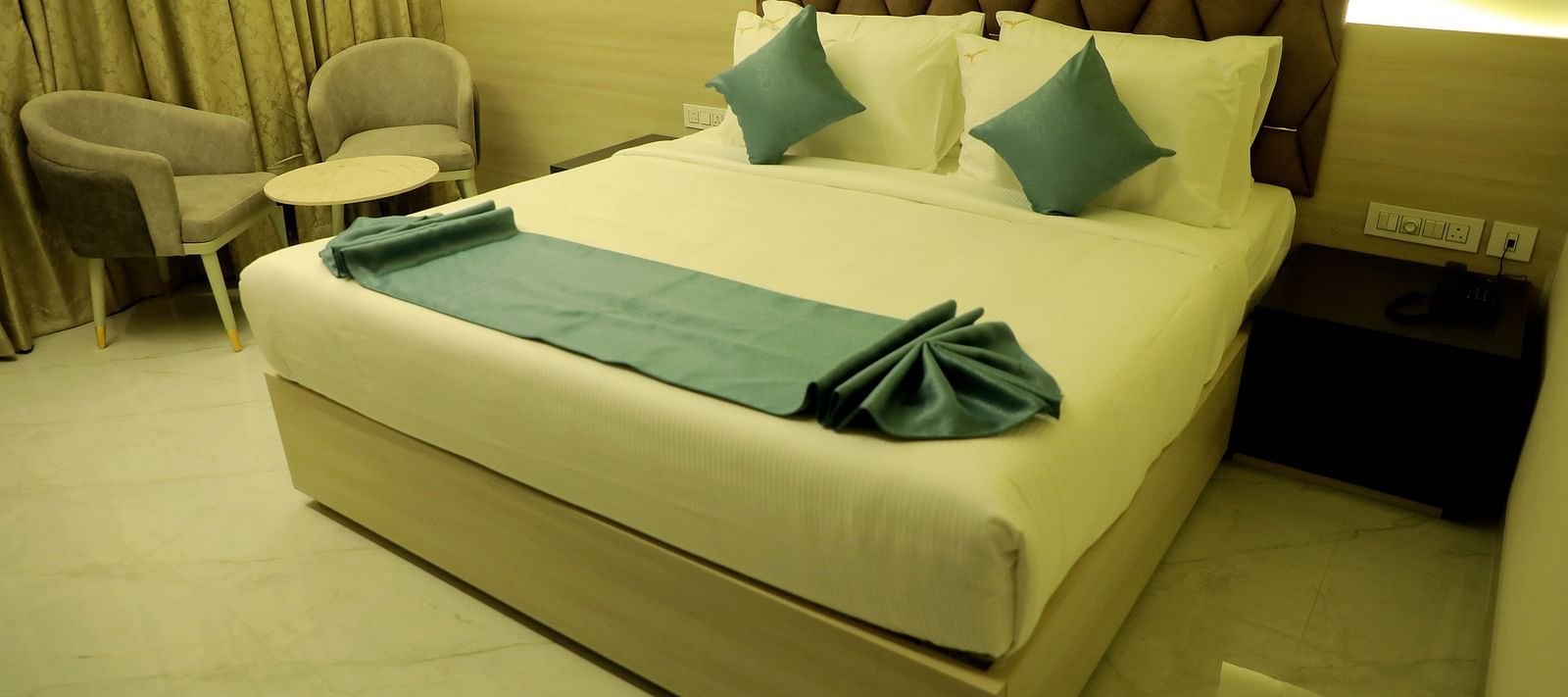 Luxurious king-size bedroom at Town Square Suites with modern decor and ambient lighting