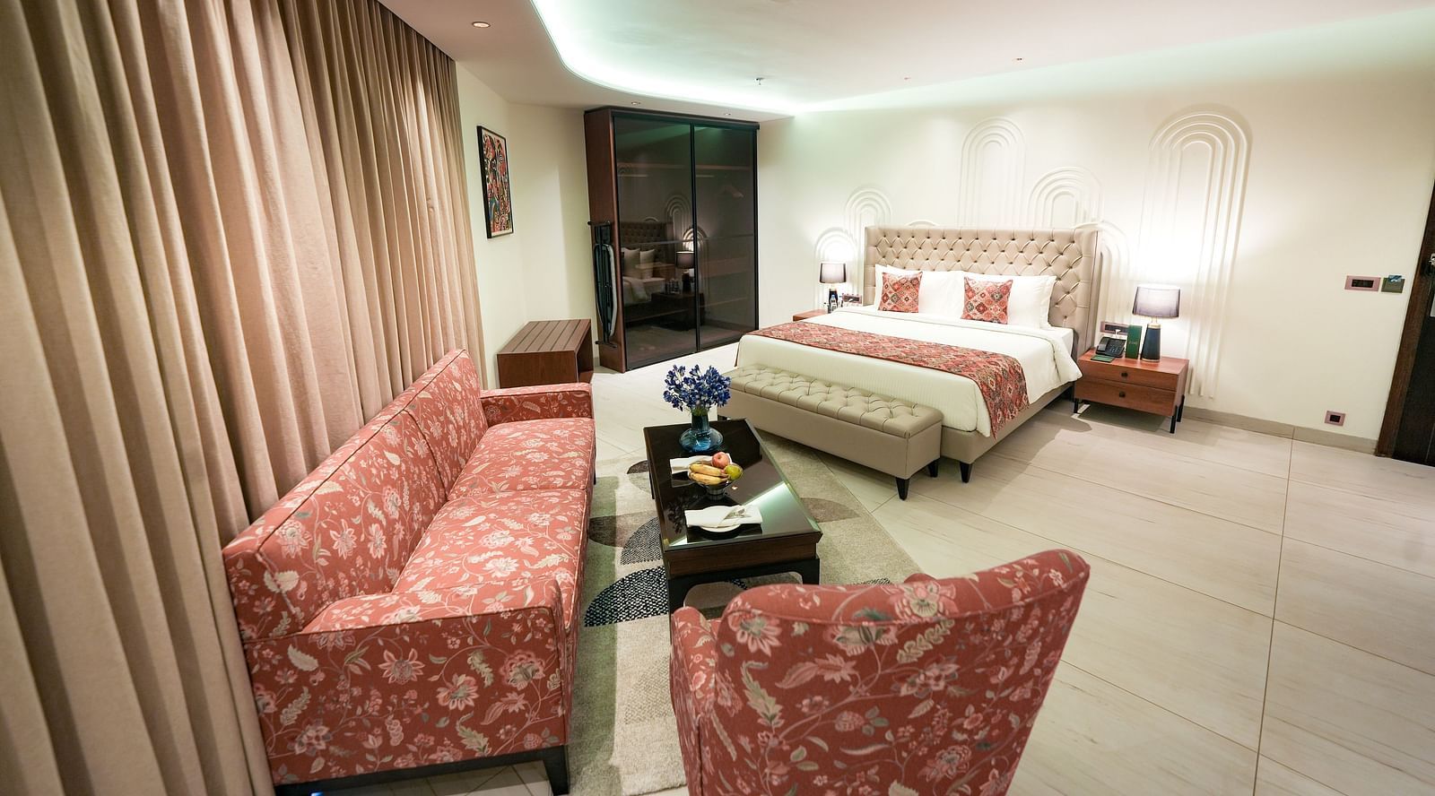 An image of Namami Suite in Bankhandi with a large queen size bed, upholstered furniture and a teapoy table - NAMAMI BY ZENQ BANKHANDI