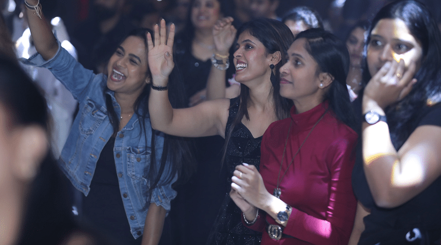 alt-text A group of people enjoying and cheering at a party at Nysa Skybar, Bengaluru.
