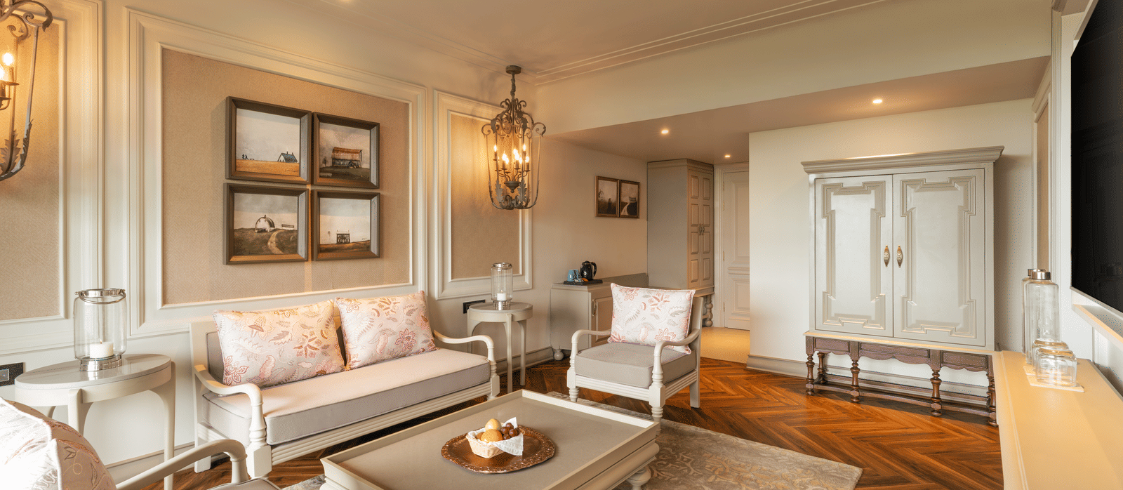 A wide-angle shot of the spacious living room at the Evren Suite featuring a beautiful couch set along with a coffee table in front of it at The Evren, Vagator.