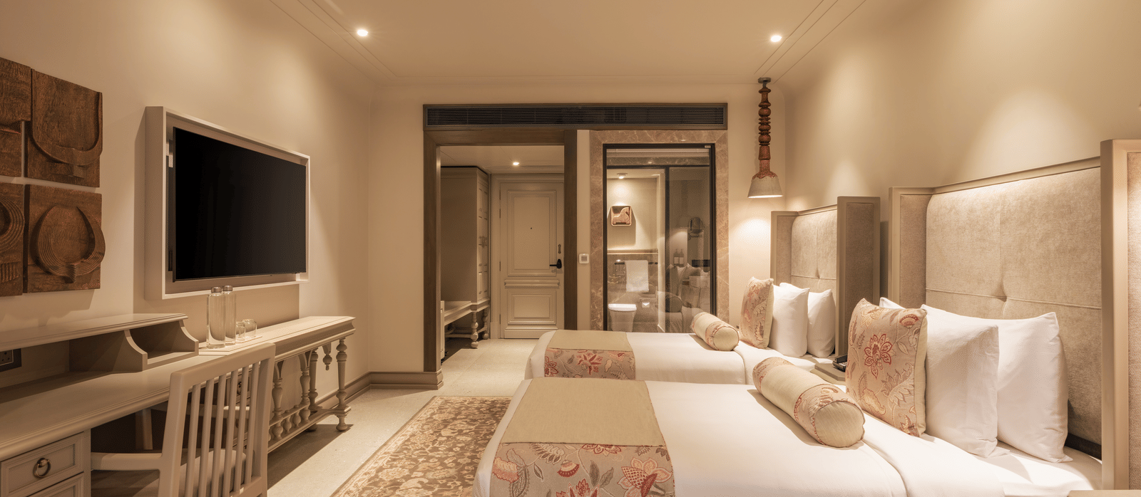 Side-view shot of the Premium Room featuring a twin bed with bright interiors at The Evren, Vagator.
