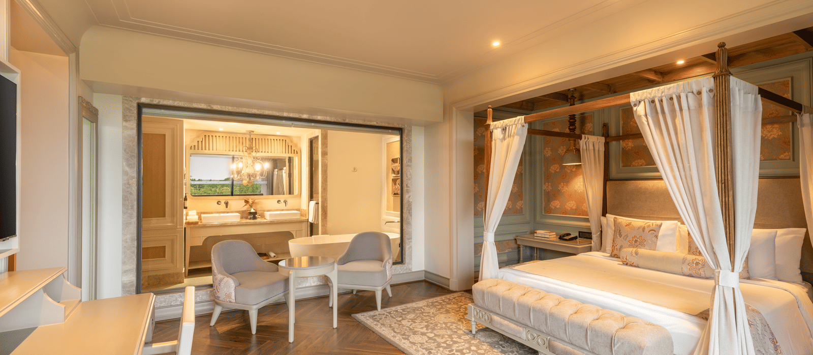 Side-view of the bedroom at the Evren Suite featuring a double bed along with a huge glass partition separating the bedroom with the bathroom at The Evren, Vagator.