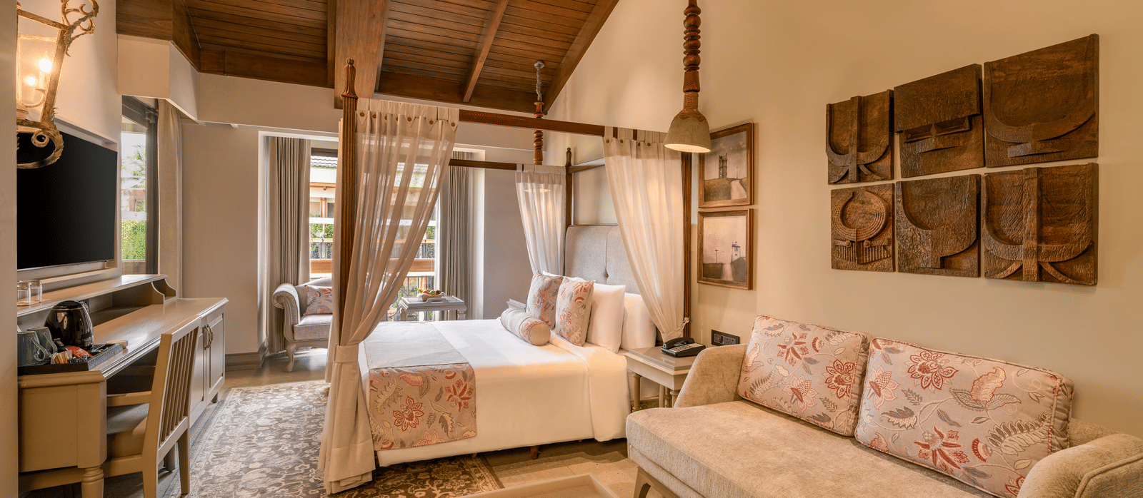 Full-view shot of the Executive Room featuring common seating area along with a double bed in the room at The Evren, Vagator.