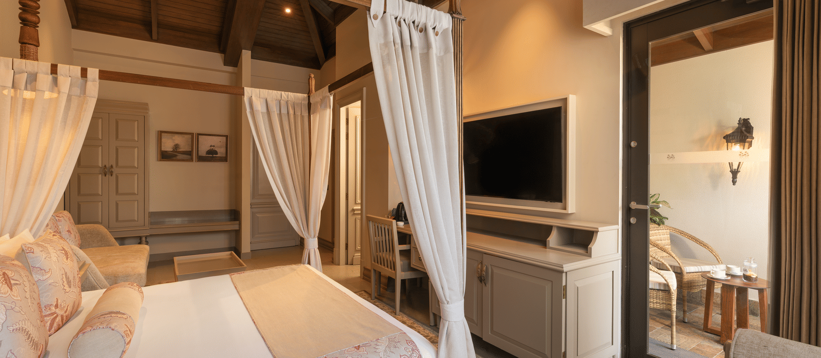 Side view of the Executive Room featuring a double bed with a television unit in front of it at The Evren, Vagator.