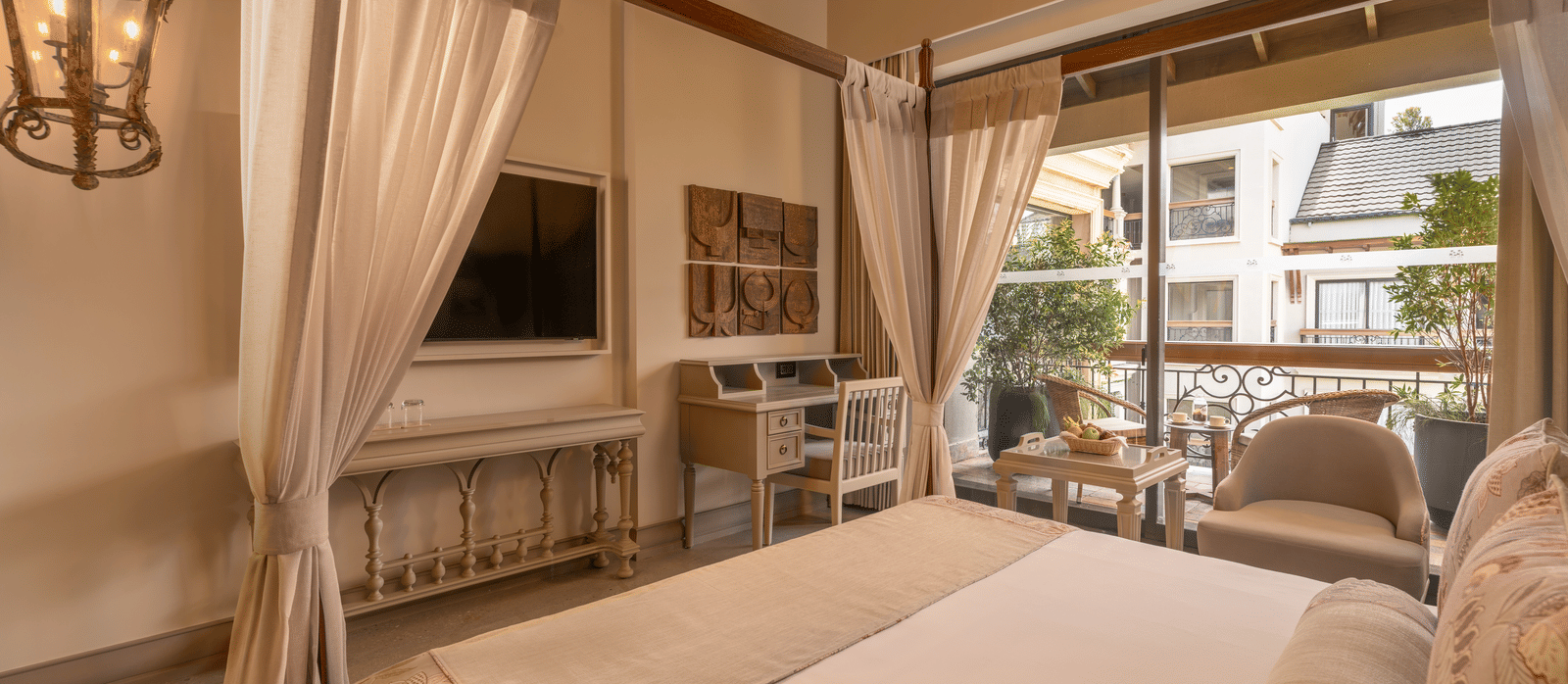 Corner view of the Premium Room featuring a double bed and wall-mounted television at The Evren, Vagator.