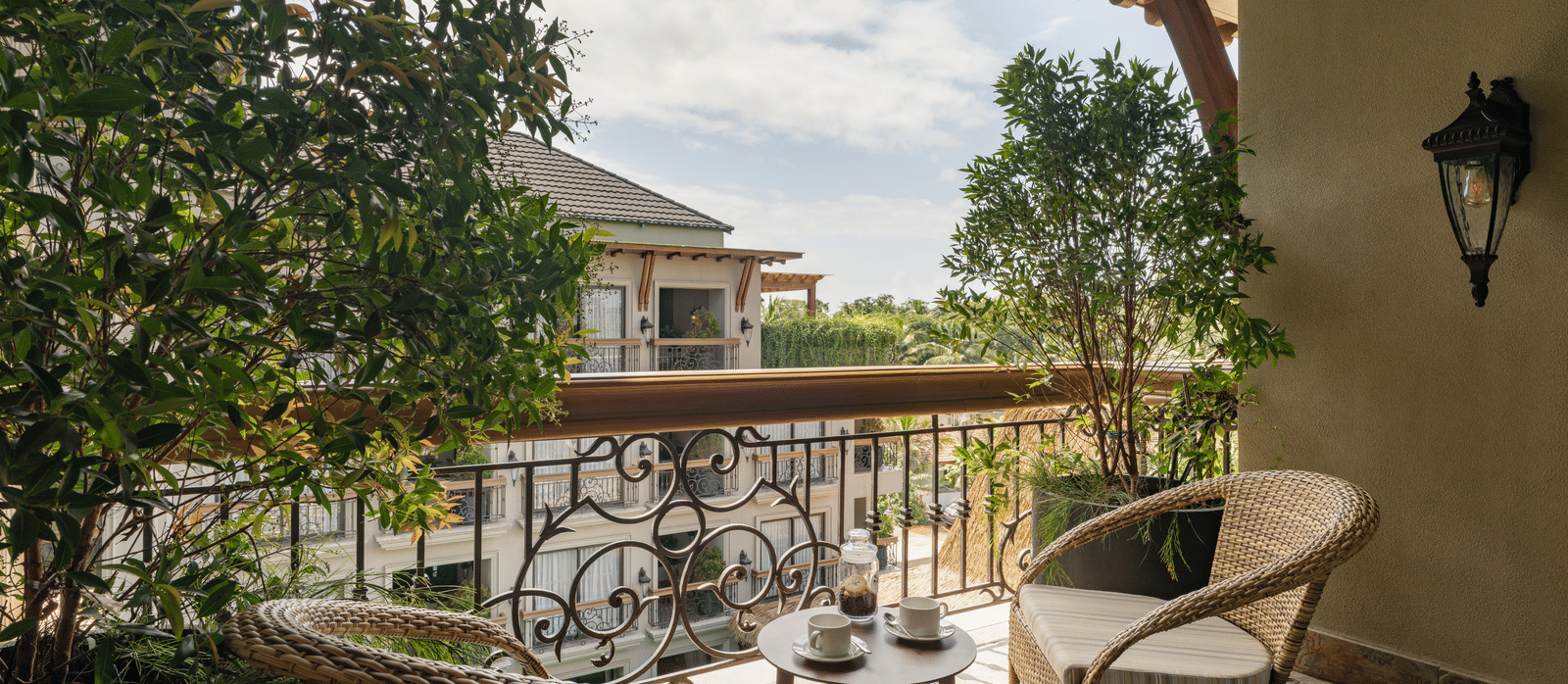 A beautiful balcony with an outdoor seating area overlooking the building opposite to it from the Premium Room at The Evren, Vagator.