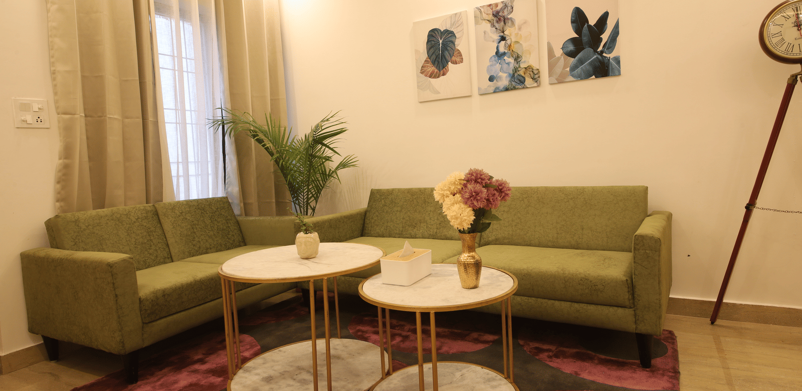 A living room, featuring an olive green sofa, 2 round white coffee tables on a purple rug, and a large floor lamp | Perfectstayz Value Homes, Mussoorie