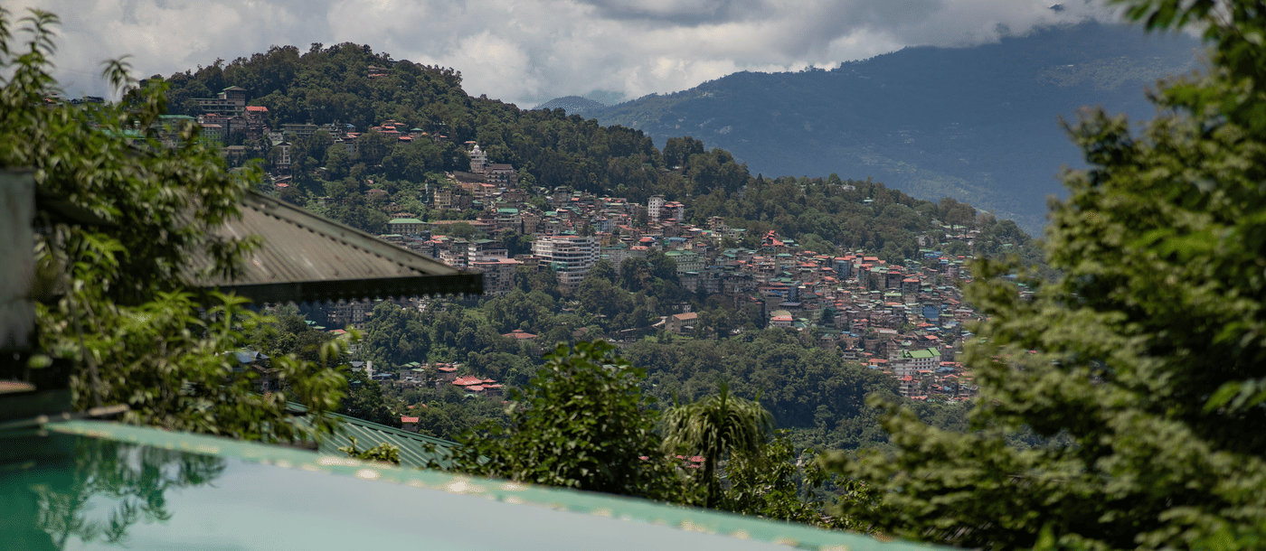 Infinity pool at Summit Hotels with a view of residential area in the hills.