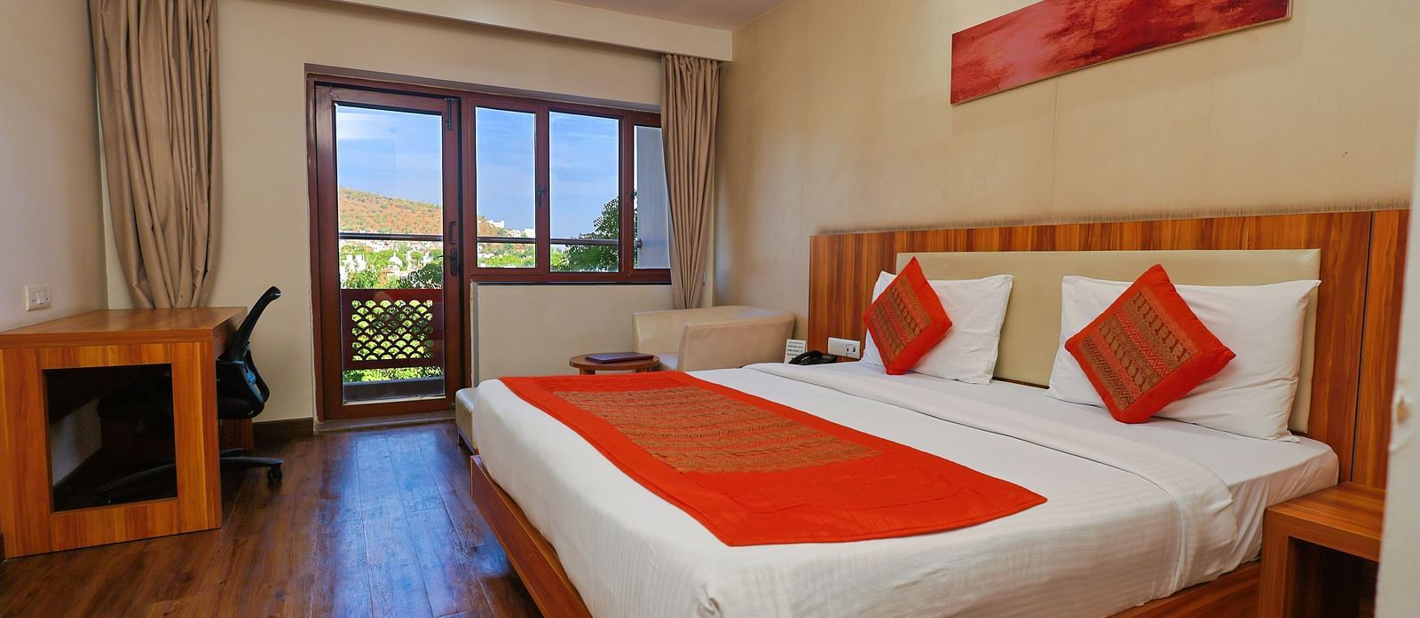 Golden Premium with Balcony and a pluhsy bed