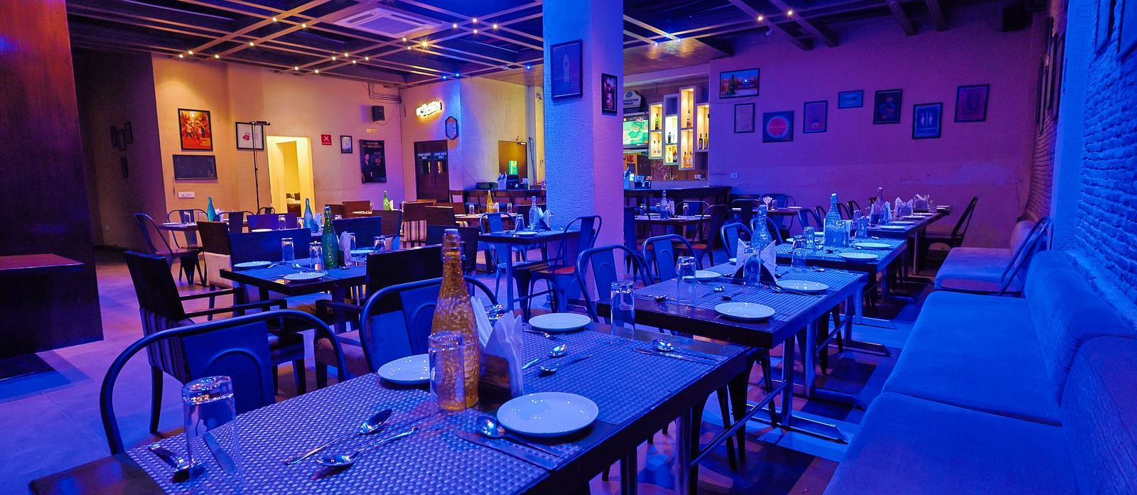  A diagonal perspective of the restaurant that emphasises the ceiling lighting and displays the overall spacious arrangement