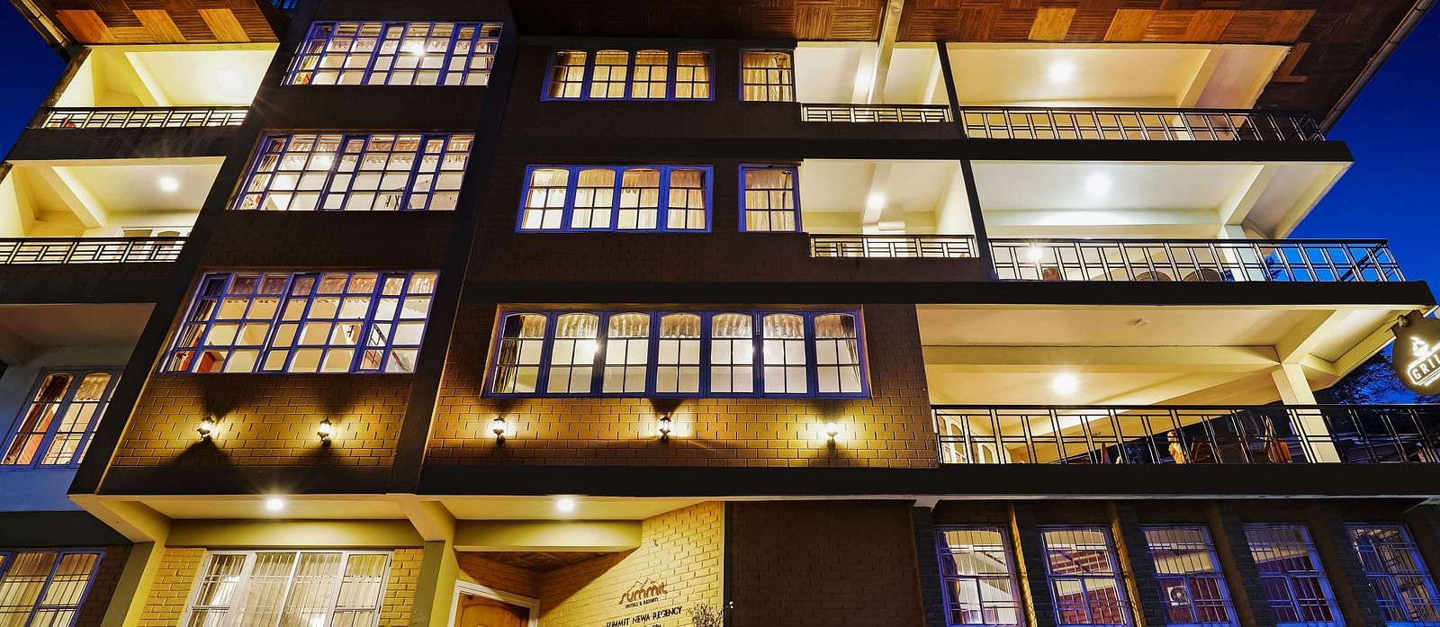 A low-high angle of a well-lit facade of Summit Newa Regency & Spa, Pelling