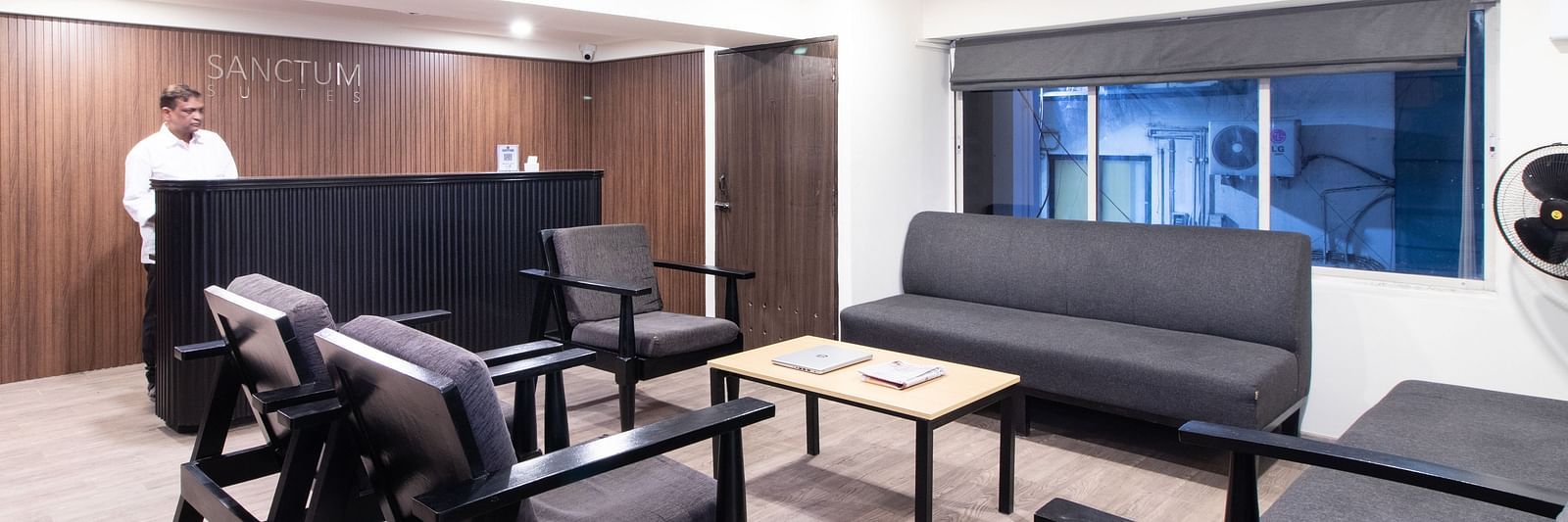 A lounge area with sofas, tables, and chairs arranged for seating - Sanctum Suites Richmond Road, Bangalore