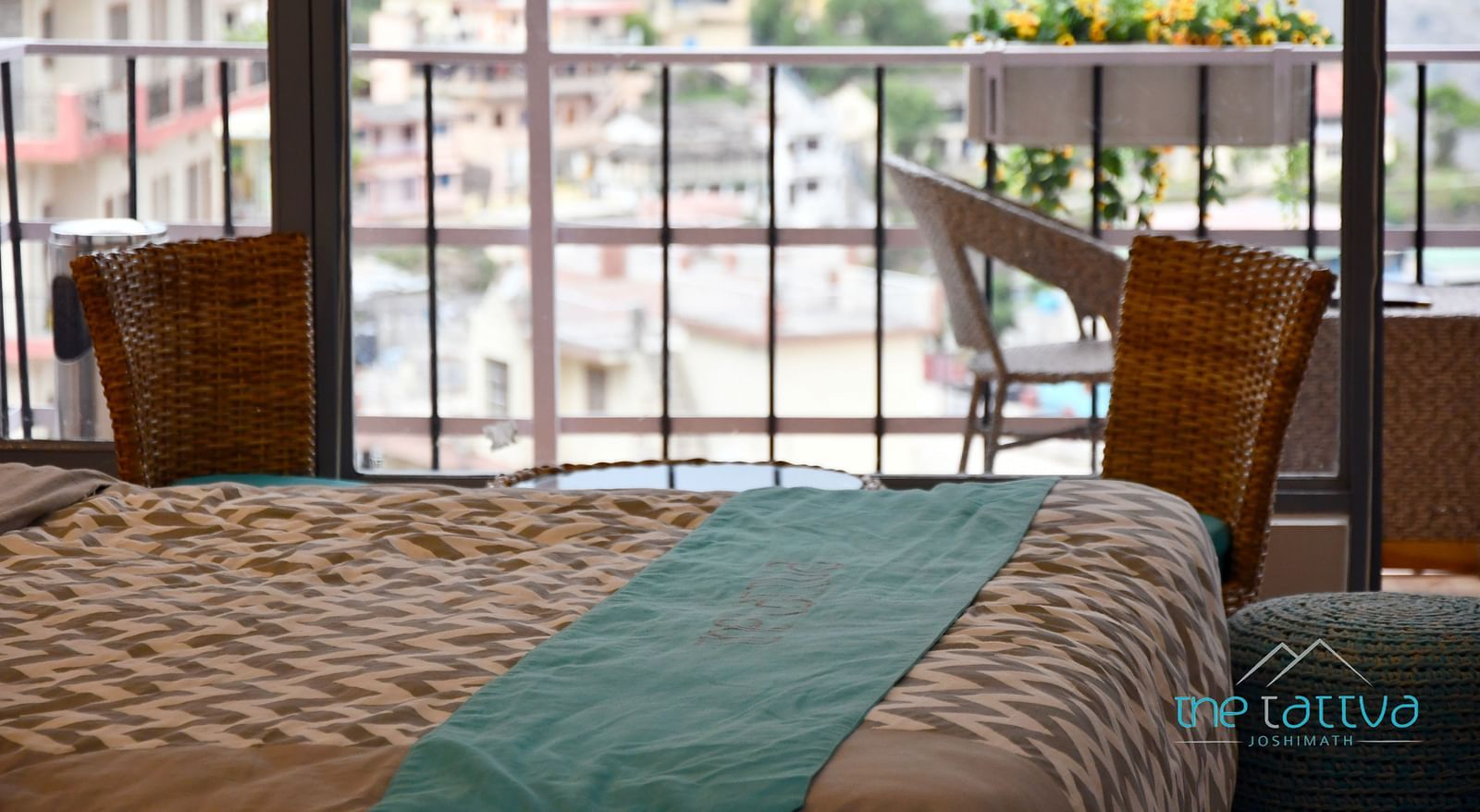 close up image of the bed in the premium room over looking the views from the balcony - The Tattva Boutique Resort